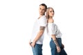 Young tattooed couple standing back to