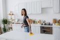 Young tattooed woman cleaning worktop with Royalty Free Stock Photo