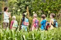 Young teacher with children on nature field trip Royalty Free Stock Photo