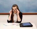 Young teacher in the class works at a table