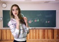 Young teacher in front of a blackboard Royalty Free Stock Photo