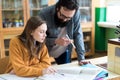 Young teacher helping his student in chemistry class. Education and Tutoring concept. Royalty Free Stock Photo