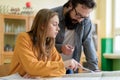 Young teacher helping his student in chemistry class. Education concept. Royalty Free Stock Photo