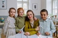 Young teacher with model of wind turbine learning pupils about wind energy. Royalty Free Stock Photo