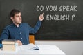 Young teacher is teaching English language at school