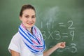 Young teacher teaching mathematics on chalkboard in classroom Royalty Free Stock Photo