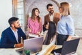 Team of coworkers making great meeting discussion in modern coworking office