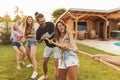 Friends playing tug of war at the backyard summertime party Royalty Free Stock Photo