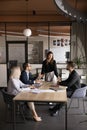 Young team manager woman talking to business colleagues at table Royalty Free Stock Photo