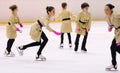 Young team from a school of skating on ice performs, disguised as detectives with raincoats, at the International Cup Ciutat