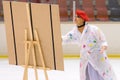 Young team from a school of skating on ice performs, disguised as painters