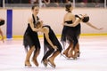 Young team from a school of skating on ice performs, disguised as sailors