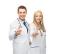 Young team of two doctors showing thumbs up Royalty Free Stock Photo