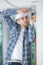 Young technician adjusting cctv camera on wall Royalty Free Stock Photo