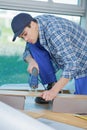 Young technician installing floor at construction site Royalty Free Stock Photo