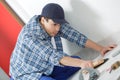 young technician installing floor at construction site Royalty Free Stock Photo