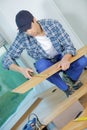 young technician installing floor at construction site Royalty Free Stock Photo