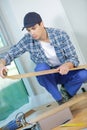 Young technician installing floor at construction site Royalty Free Stock Photo