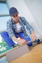 Young technician installing floor at construction site Royalty Free Stock Photo