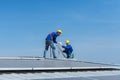 A young technician intern working on solar panels is fear of heights with senior engineers