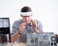Young technician repairing computer in workshop Royalty Free Stock Photo