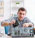 Young technician repairing computer in workshop Royalty Free Stock Photo