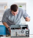 Young technician repairing computer in workshop Royalty Free Stock Photo