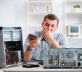 Young technician repairing computer in workshop Royalty Free Stock Photo