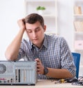 Young technician repairing computer in workshop Royalty Free Stock Photo