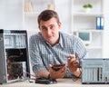 Young technician repairing computer in workshop Royalty Free Stock Photo