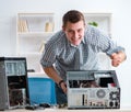 Young technician repairing computer in workshop Royalty Free Stock Photo