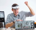 Young technician repairing computer in workshop Royalty Free Stock Photo