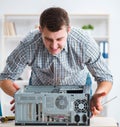 Young technician repairing computer in workshop Royalty Free Stock Photo