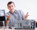 Young technician repairing computer in workshop Royalty Free Stock Photo