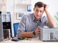 Young technician repairing computer in workshop Royalty Free Stock Photo