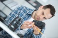 Young technician repairing digital camera in service laboratory Royalty Free Stock Photo