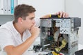 Young technician working on broken computer Royalty Free Stock Photo