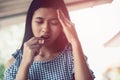 Young teen asian woman headache holding medicine and her head Royalty Free Stock Photo