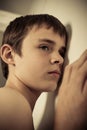 Young Teen Boy with Ear Pressed to Wall Royalty Free Stock Photo