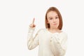 Young teen boy with long hair posing at studio. Guy pointing up at empty space. Boy gesturing new idea Royalty Free Stock Photo