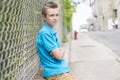 Young teen boy looking out of a fence Royalty Free Stock Photo