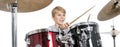 young teen boy plays the drums in studio against white background Royalty Free Stock Photo