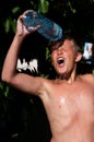 Boy pouring water on himself Royalty Free Stock Photo