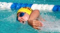 A young teen competes in freestyle swimming Royalty Free Stock Photo