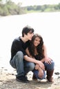 Young teen couple outdoors by river jeans