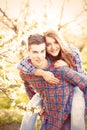 Young teen couple in the spring blossom apple trees Royalty Free Stock Photo