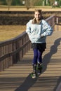 Young Teen Crossing Bridge on Stroller Skates