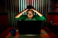 Young Teen with eyeglasses acting surprised in front of a laptop computer Royalty Free Stock Photo