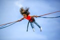 Young teen girl in bungee jumping trampoline