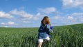 Young teen girl enjoys nature on the field. She runs under the open blue sky at dawn. Royalty Free Stock Photo